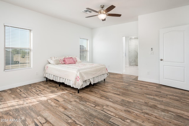 bedroom with ceiling fan and hardwood / wood-style flooring