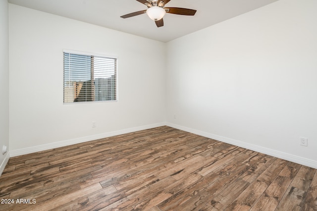 unfurnished room with ceiling fan and dark hardwood / wood-style floors