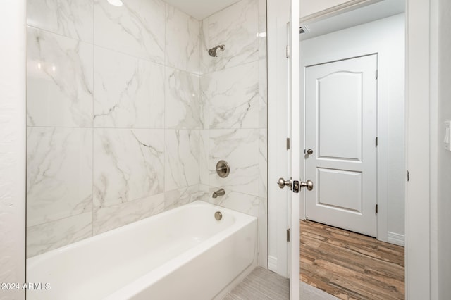 bathroom with wood-type flooring and tiled shower / bath combo