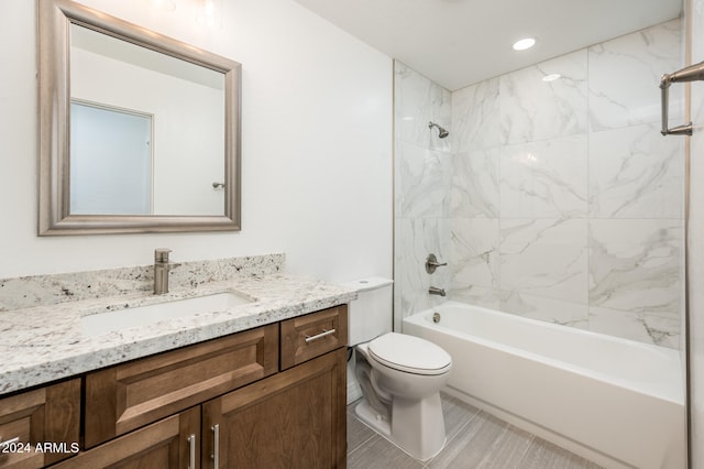 full bathroom with vanity, tiled shower / bath combo, and toilet