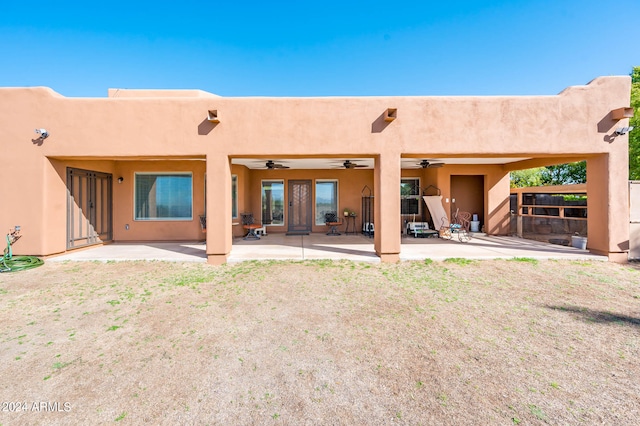 back of house with a lawn, ceiling fan, and a patio area