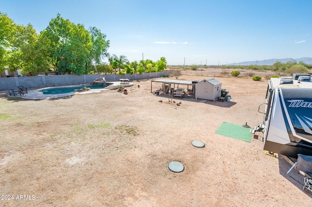 view of yard with a mountain view and a fenced in pool