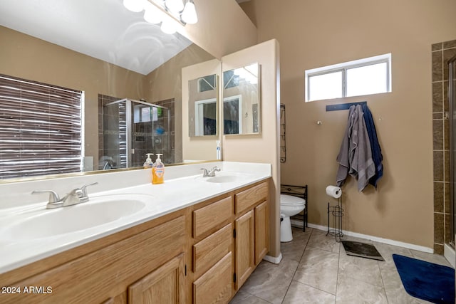 bathroom featuring toilet, vanity, and an enclosed shower