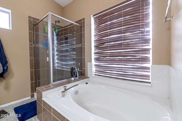 bathroom featuring independent shower and bath and tile patterned flooring