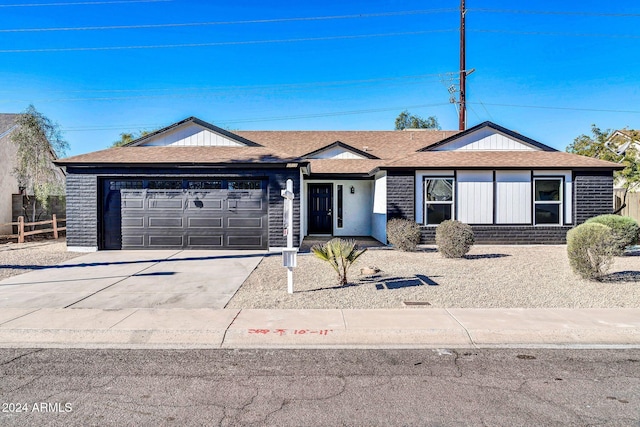 ranch-style house featuring a garage