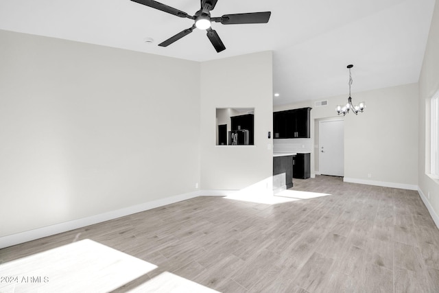 unfurnished living room featuring light hardwood / wood-style floors and ceiling fan with notable chandelier