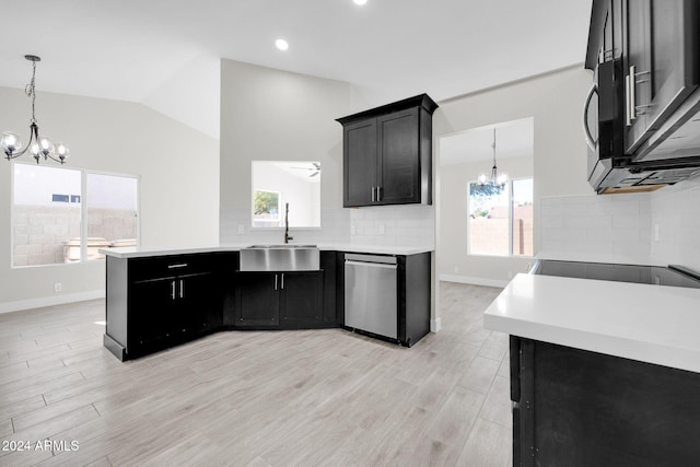 kitchen with sink, tasteful backsplash, light hardwood / wood-style flooring, stainless steel dishwasher, and ceiling fan with notable chandelier