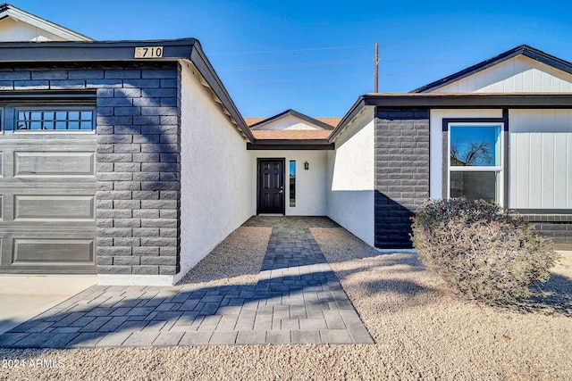 view of exterior entry with a garage