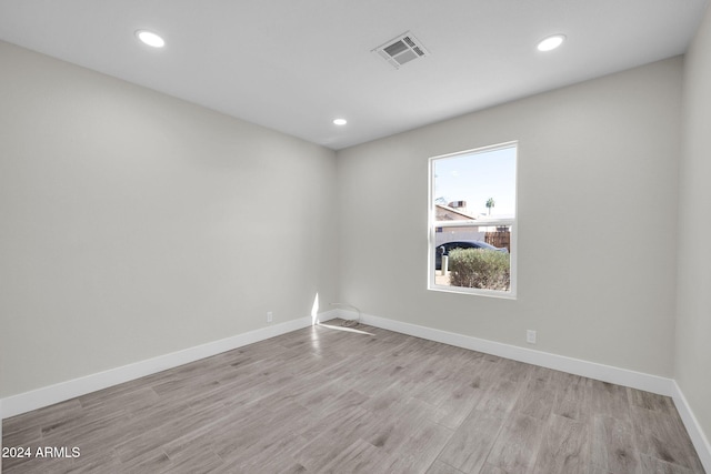 unfurnished room with light wood-type flooring