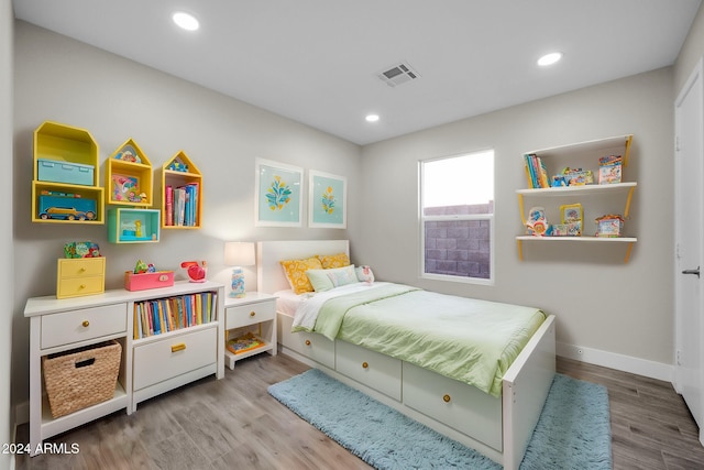 bedroom with hardwood / wood-style floors