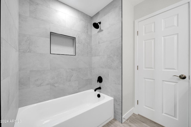 bathroom featuring hardwood / wood-style flooring and tiled shower / bath