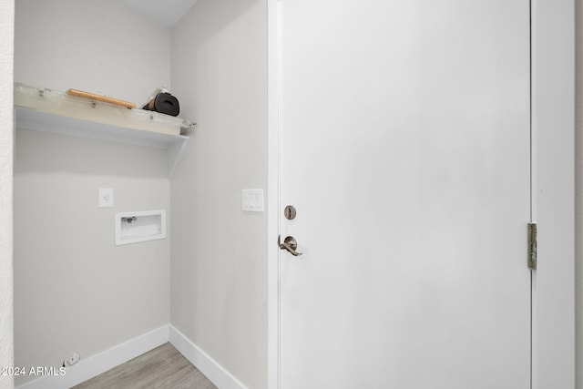 laundry area with hookup for an electric dryer, light hardwood / wood-style floors, and washer hookup