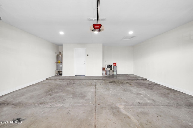 garage with water heater and a garage door opener