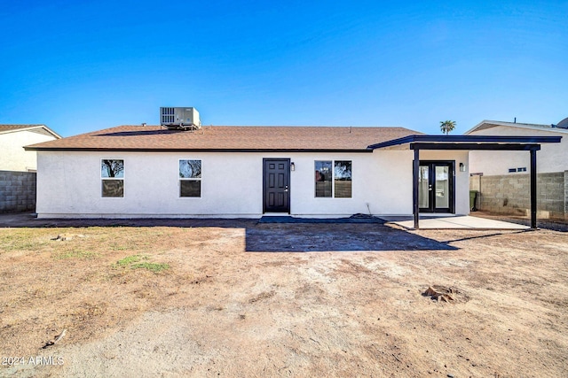 rear view of property with french doors and cooling unit