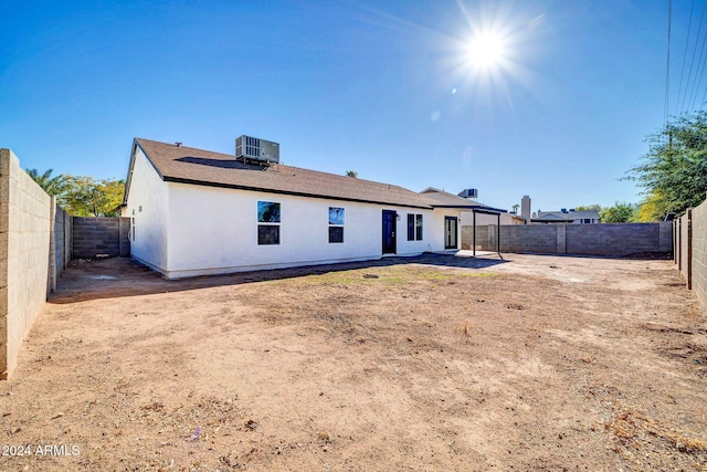 back of house with cooling unit and a patio