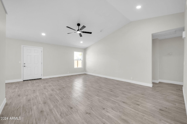 spare room featuring ceiling fan, vaulted ceiling, and light hardwood / wood-style flooring