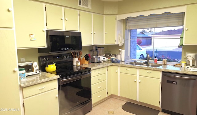 kitchen featuring black range with electric stovetop, a sink, visible vents, light countertops, and stainless steel dishwasher