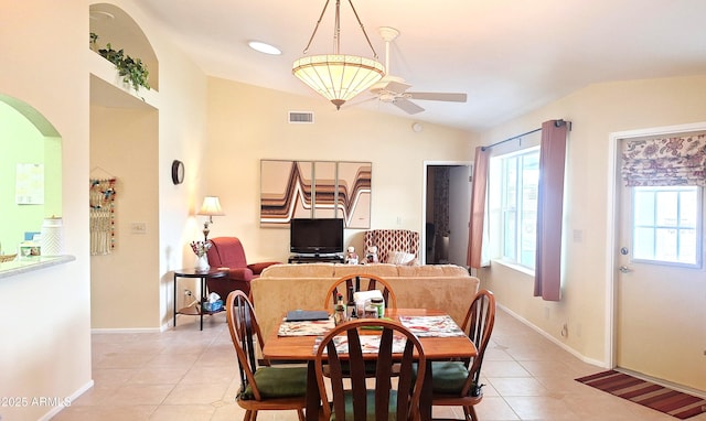 dining space featuring lofted ceiling, light tile patterned floors, ceiling fan, and visible vents