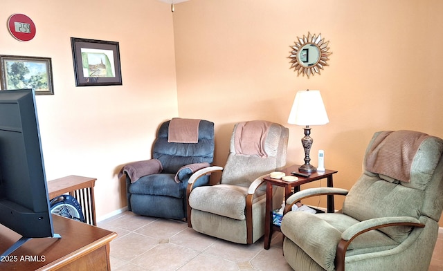 sitting room featuring baseboards and light tile patterned floors