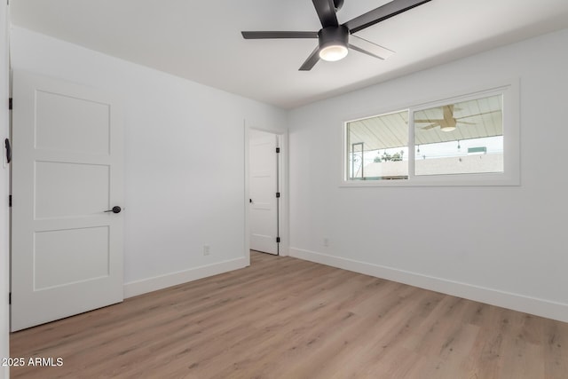 unfurnished bedroom with baseboards and light wood-style flooring