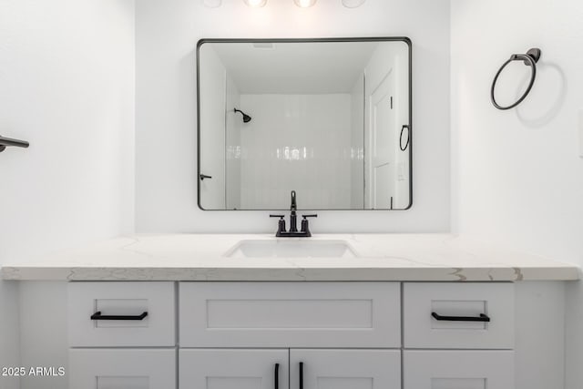 full bath featuring vanity and a shower