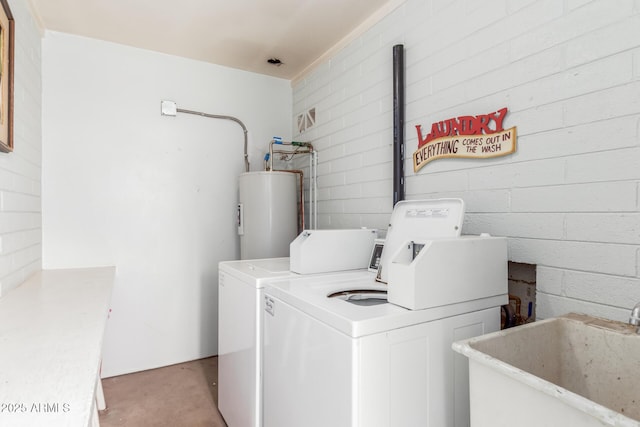 laundry area featuring water heater, light colored carpet, a sink, and washer and clothes dryer