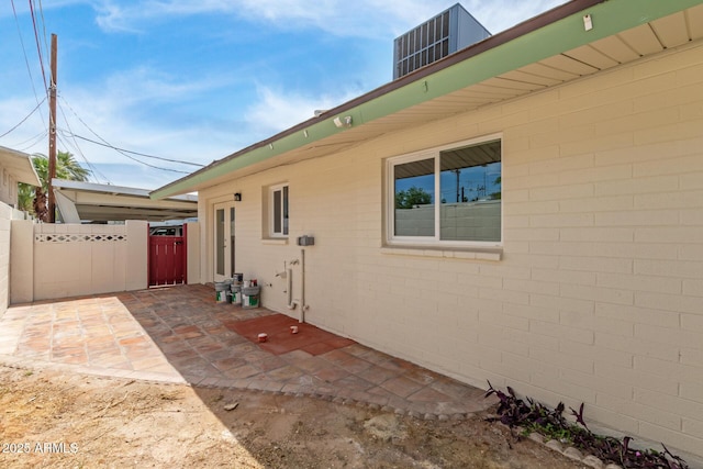 view of home's exterior with fence and a patio area