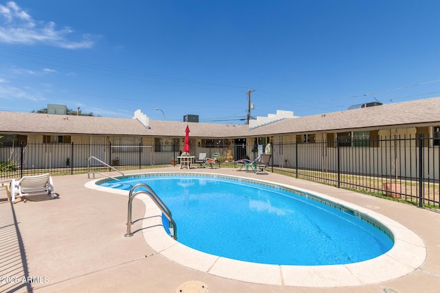 pool featuring fence and a patio area