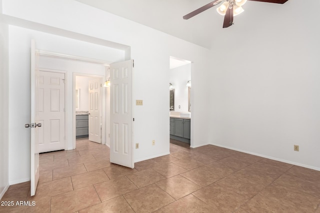 tiled empty room featuring ceiling fan