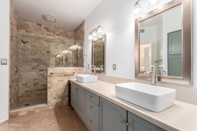 bathroom with vanity, tile patterned floors, and a shower with shower door