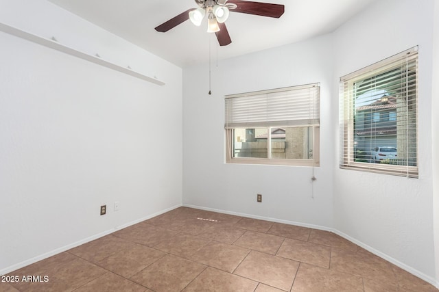 tiled spare room with ceiling fan