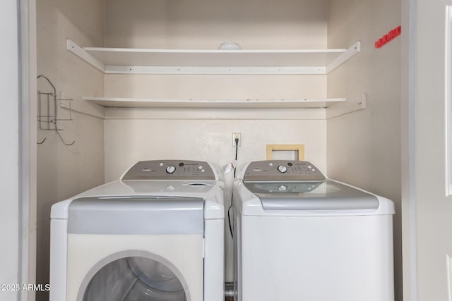 washroom featuring washer and clothes dryer