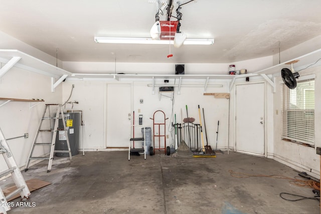 garage featuring a garage door opener and water heater