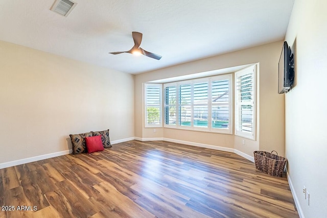 empty room featuring hardwood / wood-style floors and ceiling fan