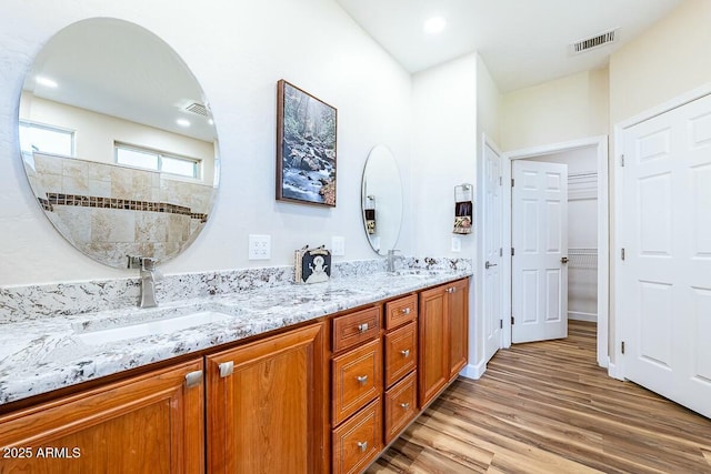 bathroom with vanity, hardwood / wood-style flooring, and walk in shower