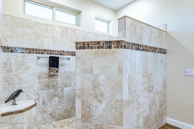 bathroom with tiled shower