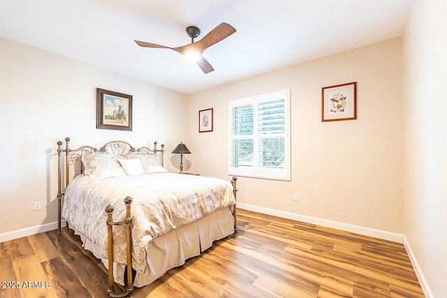 bedroom with light wood-type flooring and ceiling fan