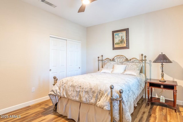 bedroom featuring hardwood / wood-style flooring, a closet, and ceiling fan