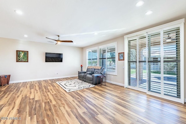 unfurnished living room featuring ceiling fan and light hardwood / wood-style flooring