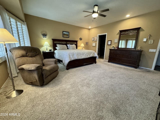 carpeted bedroom featuring ceiling fan and multiple windows