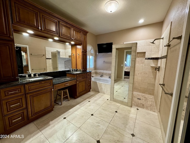 bathroom with tile patterned floors, vanity, and separate shower and tub