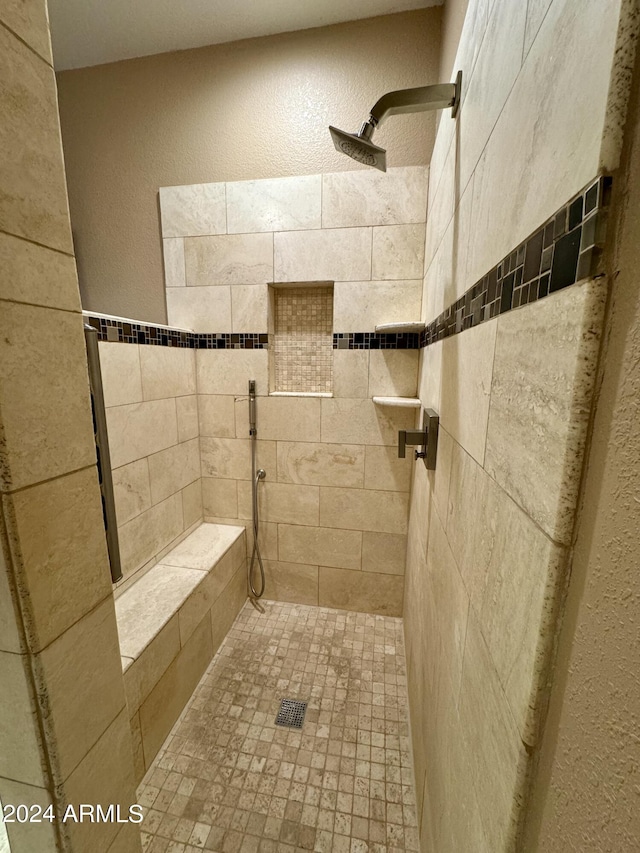 bathroom with a tile shower