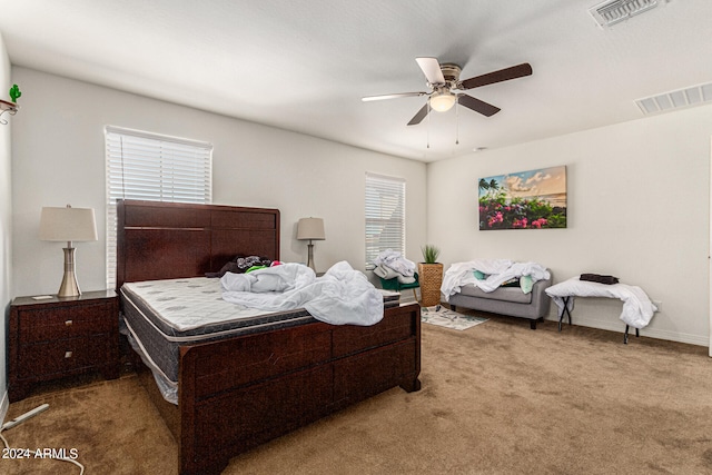 bedroom featuring ceiling fan and light colored carpet