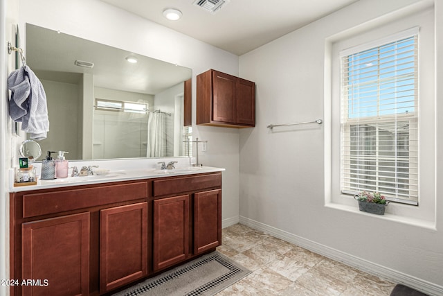 bathroom featuring vanity and curtained shower