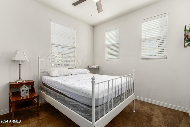 bedroom with ceiling fan and dark carpet