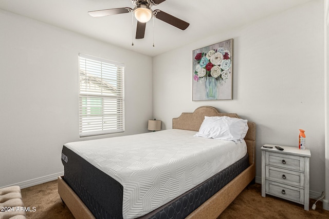 bedroom featuring ceiling fan and dark carpet