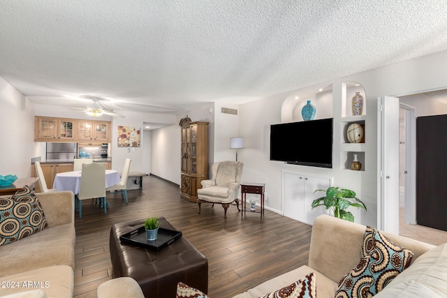 living room with ceiling fan, hardwood / wood-style floors, and a textured ceiling