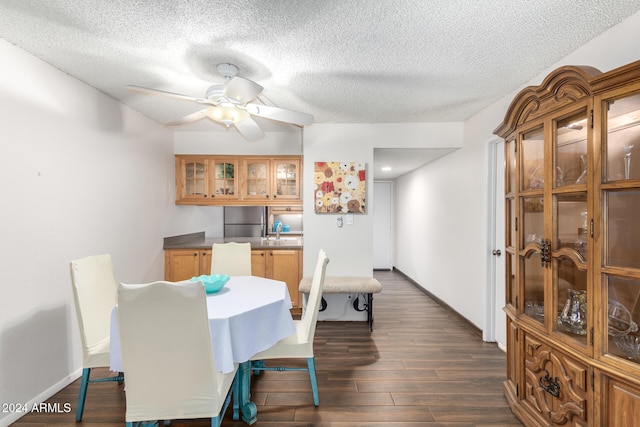 dining area with a textured ceiling, dark hardwood / wood-style flooring, ceiling fan, and sink