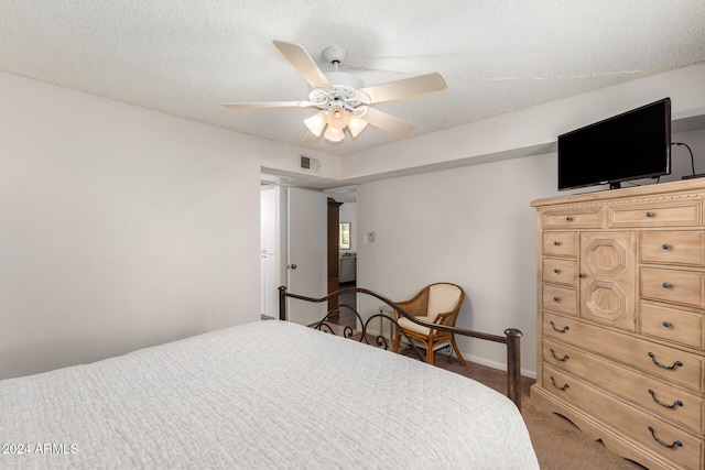 bedroom with ceiling fan, dark carpet, and a textured ceiling