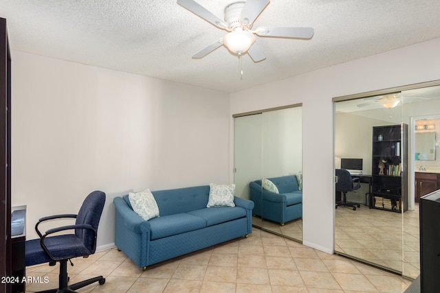 tiled office featuring ceiling fan and a textured ceiling